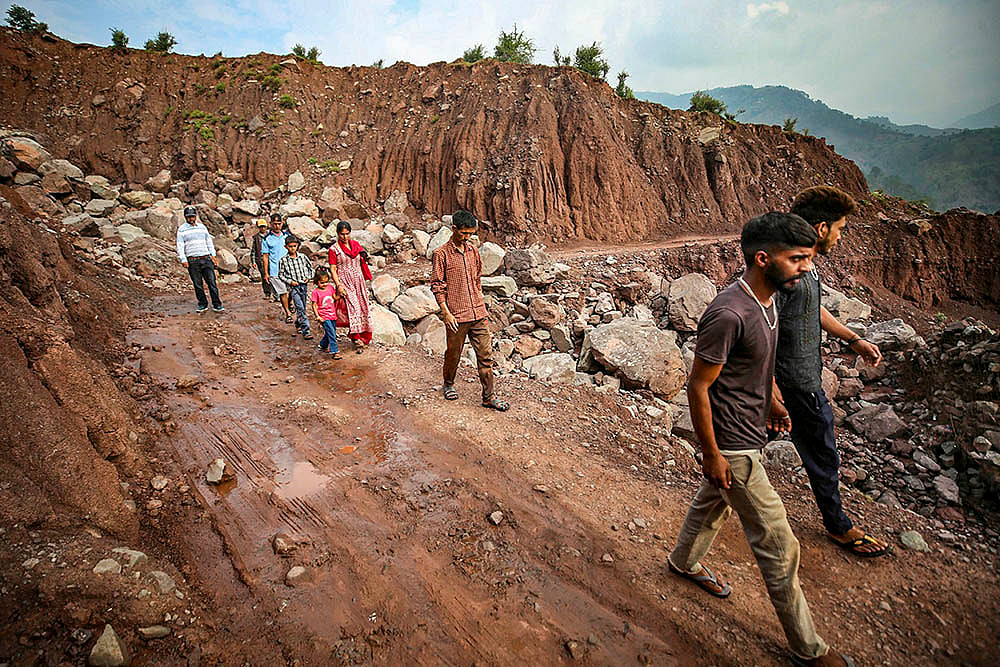 | Photo: PTI : Road damaged near militant attack site in Kathua